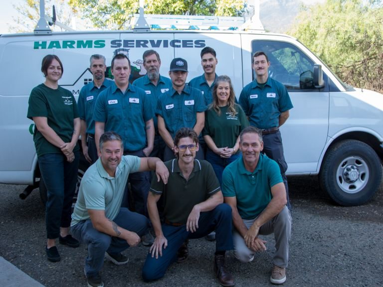 Meet the Harms Services team Harms Services plumbing team gathered in front of the branded company van